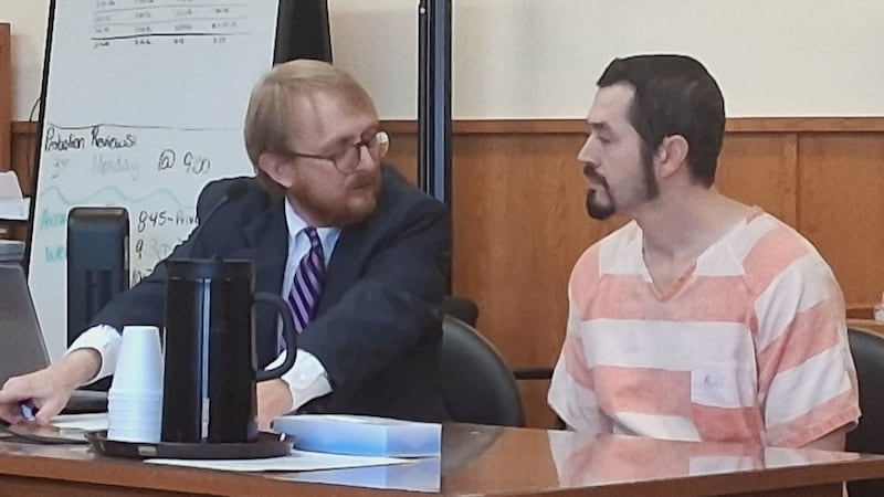 Rafael Valenzuela (right) confers with his attorney, Adams County Public Defender John Citro,...